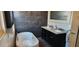 Modern bathroom with a sleek tub, dual sink vanity, and stylish gray tile accents at 1550 Chateau Wood Dr, Clearwater, FL 33764