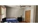 Bedroom features modern ceiling fan and a well-organized closet with slat doors at 1550 Chateau Wood Dr, Clearwater, FL 33764