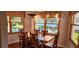 Cozy dining room with a view of the backyard pool through large windows at 1550 Chateau Wood Dr, Clearwater, FL 33764