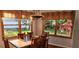 Dining room featuring hardwood floors, large windows, and a wooden dining table at 1550 Chateau Wood Dr, Clearwater, FL 33764