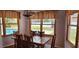 Dining room with hardwood floors, wooden dining table, and backyard view at 1550 Chateau Wood Dr, Clearwater, FL 33764