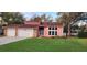 Charming home with a well-manicured lawn and a spacious two-car garage at 1550 Chateau Wood Dr, Clearwater, FL 33764