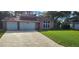 Charming home with a well-manicured lawn and a spacious two-car garage at 1550 Chateau Wood Dr, Clearwater, FL 33764