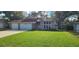 Charming two-story home featuring a well-manicured lawn and a spacious three-car garage at 1550 Chateau Wood Dr, Clearwater, FL 33764
