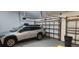 Epoxy garage with car parked inside and space for storage of bins and trash cans at 1550 Chateau Wood Dr, Clearwater, FL 33764