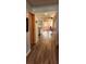 Hallway view leading to the living room and dining area, with hardwood floors at 1550 Chateau Wood Dr, Clearwater, FL 33764