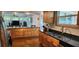 Spacious kitchen featuring updated appliances, granite countertops, and a stainless steel sink at 1550 Chateau Wood Dr, Clearwater, FL 33764