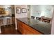Open kitchen featuring a large island with granite countertops and wooden cabinets at 1550 Chateau Wood Dr, Clearwater, FL 33764