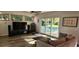 Cozy living room leading to pool, with hardwood floors, and comfortable seating at 1550 Chateau Wood Dr, Clearwater, FL 33764