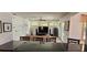 Open-concept living room with hardwood floors, ceiling fan, and sliding glass doors to the backyard at 1550 Chateau Wood Dr, Clearwater, FL 33764