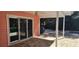 Covered outdoor patio area with sliding glass doors and brick pavers at 1550 Chateau Wood Dr, Clearwater, FL 33764
