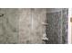 The shower features stylish tile walls and sleek fixtures at 1550 Chateau Wood Dr, Clearwater, FL 33764