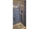 Modern shower with sleek glass door and beautiful blue mosaic tile design at 1550 Chateau Wood Dr, Clearwater, FL 33764