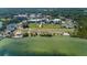 Aerial view of waterfront property featuring a beach area and a modern hotel amidst a park-like setting at 1857 Castle Woods Dr, Clearwater, FL 33759