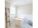 Elegant bathroom features a freestanding tub with a modern faucet and a towel ladder at 1857 Castle Woods Dr, Clearwater, FL 33759
