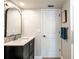 Bathroom features an ornate mirror above the sink with a black cabinet at 1857 Castle Woods Dr, Clearwater, FL 33759