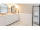 Stylish bathroom with double vanity, framed mirrors, marble countertop and towel ladder at 1857 Castle Woods Dr, Clearwater, FL 33759