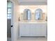 Elegant bathroom features a dual sink vanity and a separate shower room at 1857 Castle Woods Dr, Clearwater, FL 33759