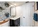 Bright bathroom with patterned accent wall, modern vanity and tiled floor at 1857 Castle Woods Dr, Clearwater, FL 33759