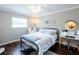 Cozy bedroom with a white and blue bed and large window with a cushioned bench at 1857 Castle Woods Dr, Clearwater, FL 33759