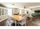 Open dining area with a large table, hardwood floors, and access to the living room at 1857 Castle Woods Dr, Clearwater, FL 33759