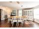 Bright dining room featuring hardwood floors, wooden table and white china cabinet at 1857 Castle Woods Dr, Clearwater, FL 33759