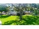 Charming two-story home with lush front yard and mature trees with Spanish moss at 1857 Castle Woods Dr, Clearwater, FL 33759