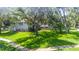 Charming two-story home with a well-manicured lawn and mature trees in a quiet neighborhood at 1857 Castle Woods Dr, Clearwater, FL 33759