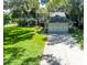 Front exterior of the two-story home with a driveway and basketball hoop at 1857 Castle Woods Dr, Clearwater, FL 33759