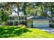 Charming two-story home with a well-manicured lawn and a two car garage at 1857 Castle Woods Dr, Clearwater, FL 33759