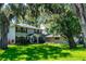 Charming two-story home with well-manicured lawn, mature landscaping, and attached garage at 1857 Castle Woods Dr, Clearwater, FL 33759