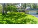 Beautiful two-story home featuring a lush front yard with mature trees and attached two-car garage at 1857 Castle Woods Dr, Clearwater, FL 33759