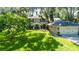 Exterior view of a two-story home featuring a lush green lawn and attached two-car garage at 1857 Castle Woods Dr, Clearwater, FL 33759