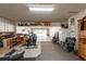 Spacious two-car garage with overhead storage, gym equipment, and access to the backyard at 1857 Castle Woods Dr, Clearwater, FL 33759