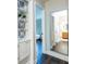 Bright hallway featuring hardwood floors, a large mirror, and a charming built-in display cabinet at 1857 Castle Woods Dr, Clearwater, FL 33759