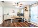 Cozy home office with hardwood floors, built-in shelving, and bright windows at 1857 Castle Woods Dr, Clearwater, FL 33759