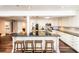 Spacious kitchen with bar seating, stainless steel appliances, and hardwood floors at 1857 Castle Woods Dr, Clearwater, FL 33759
