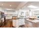 Large kitchen featuring white cabinets, granite countertops, and stainless steel appliances, open to the living room at 1857 Castle Woods Dr, Clearwater, FL 33759