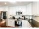 Well-equipped kitchen with white cabinets, stainless steel appliances, and granite countertops at 1857 Castle Woods Dr, Clearwater, FL 33759