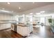 Spacious kitchen with white cabinets, granite countertops, and an open layout connected to living area at 1857 Castle Woods Dr, Clearwater, FL 33759