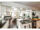 Modern kitchen with black countertops and stainless steel appliances, open to living area at 1857 Castle Woods Dr, Clearwater, FL 33759