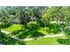 Expansive lawn surrounds the home, creating a serene and picturesque setting at 1857 Castle Woods Dr, Clearwater, FL 33759