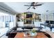 Cozy living room with fireplace, wood floors, and access to an outdoor kitchen at 1857 Castle Woods Dr, Clearwater, FL 33759