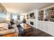 Comfortable living room featuring hardwood floors, fireplace, and bright windows at 1857 Castle Woods Dr, Clearwater, FL 33759