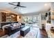 Cozy living room with leather sofa, area rug, and screened-in porch at 1857 Castle Woods Dr, Clearwater, FL 33759