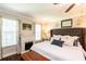 Bright main bedroom features hardwood floors, a fireplace, and a plush king-sized bed at 1857 Castle Woods Dr, Clearwater, FL 33759