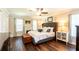 Relaxing main bedroom features hardwood floors, a fireplace, and large windows at 1857 Castle Woods Dr, Clearwater, FL 33759