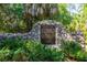 A stone monument identifies the Philippe Park and provides historical information amidst lush greenery and mature trees at 1857 Castle Woods Dr, Clearwater, FL 33759