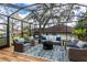 Inviting screened-in patio boasts ample seating, a cozy fire pit, and a relaxing atmosphere at 1857 Castle Woods Dr, Clearwater, FL 33759
