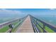 Long pier over tranquil water, offering a scenic walkway to a covered gazebo at 1857 Castle Woods Dr, Clearwater, FL 33759
